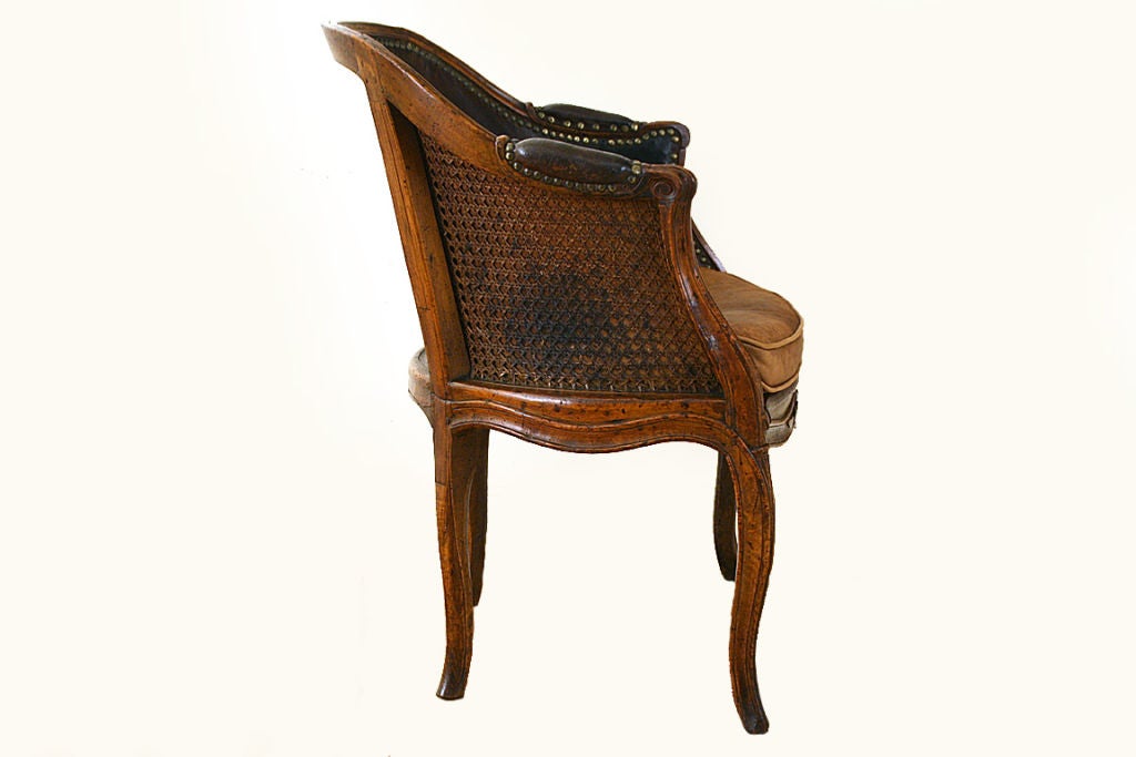 18th Century and Earlier Louis XV Period Walnut, Caned, and Leather Upholstered Bergere