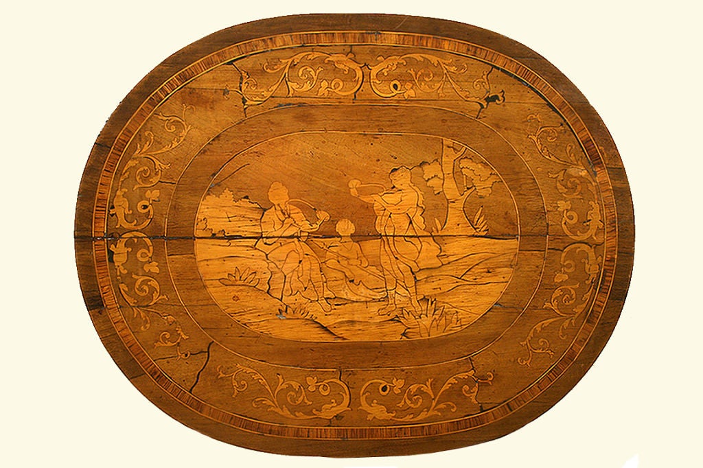 Italian, Lombardia, Louis XIV Walnut and Inlaid Oval Table, having a central inlaid top depicting three figures in repose, two playing instruments, the other sitting with his spear, the concentric outer bands separated by band inlays of fruitwood