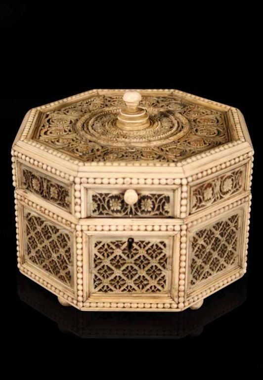 # S176 - Russian Ivory filigree-mounted octagonal shaped box. The hinged lid having a central knop surrounded by carved concentric circles, delicate vine work and beaded border, the eight side panels having pierced trellis panels within beading on 4