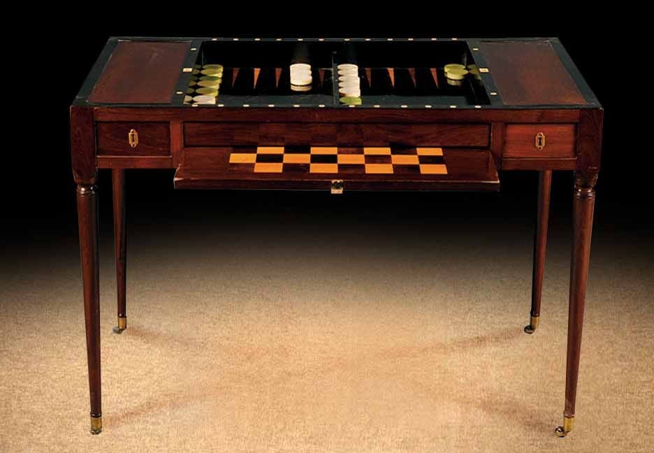 Fine Louis XVI mahogany, part-ebonized and ivory-inlaid Trictrac table, the rectangular reversible top with felt and leather linings to opposite sides enclosing the interior fitted with a backgammon board and  removable chess board.  The molded