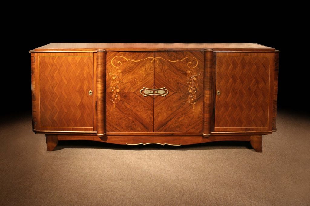 # Q268. Art Deco large four-door side cabinet attributed to Jules Leleu (1883-1961). Executed in mahogany with fruitwood satinwood, inlays. Note the decorative all-over marquetry diamond pattern. The pair of center doors with quarter sawn and book