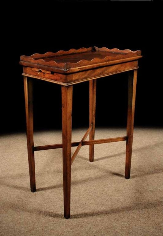 # S011 - George III mahogany kettle stand having a rectangular top with a scalloped gallery and a pull-out slide in the apron. Percy Macquid illustrates several related examples in his 