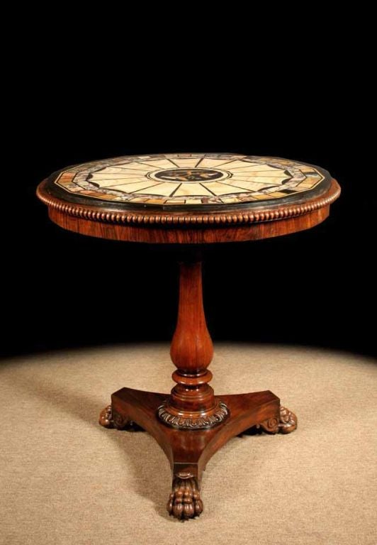 Late Regency rosewood pietra dura and specimen marble center table. The decorative round top centered by a pair of perching birds in a surround of radiating segments and with a border of colored marble specimens framed within a carved rosewood