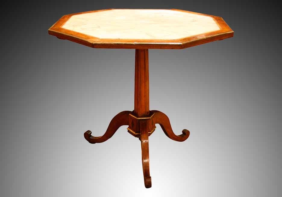 Directoire octagonal table executed in walnut and enriched with decorative inlays and metal mounts. This elegant form embodies the simple restrained style that typifies the Directoire period. The brass banded top with an inset white marble and all