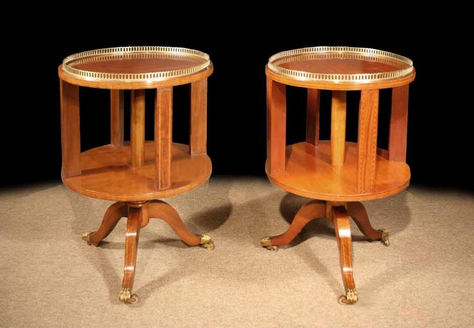 # S097 - Matched pair of Edwardian two-tier round tables executed in satinwood and enriched with decorative boxwood inlays.
The circular brass galleried top with diagonal checkered stringing, above a shelf and raised on tripod inlaid sabre legs