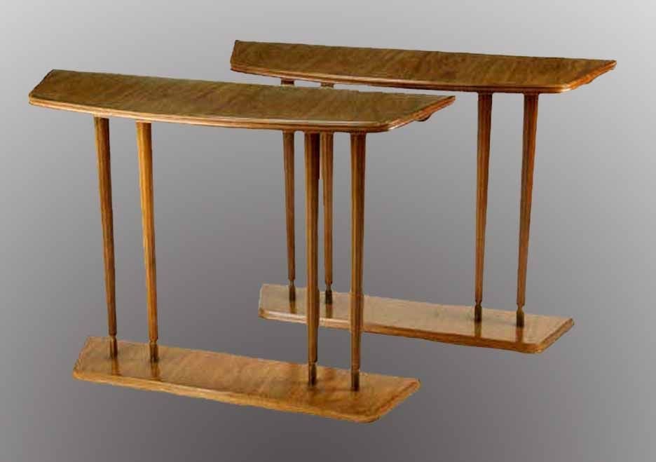 PAIR Art Deco side tables, by Laszlo Hoenig, with his metal tag on the underside. The shaped bow front tops above a fluted frieze, raised on slender fluted tapering legs ending in brass feet resting on shaped plinth bases.Laszlo Hoenig was an