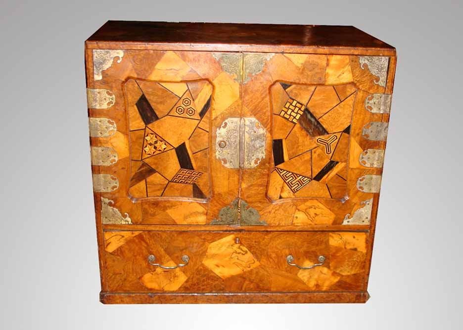 Japanese parquetry small cabinet all beautifully inlaid with decorative exotic woods. Note the expert parquetry work with well figured veneers which create an all over geometric design enriched with ebonized geometric inlay patterns. Fitted with