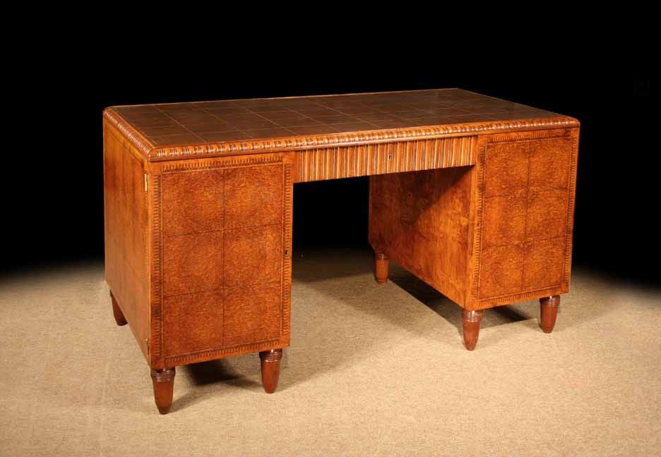 # S535 - Fabulous French Art Deco Amboyna pedestal desk  (writing library table), attributed to Paul Follot . The leather top with gold tooled panels and surrounded by a wood border which has a carved and molded edge. The center section has one