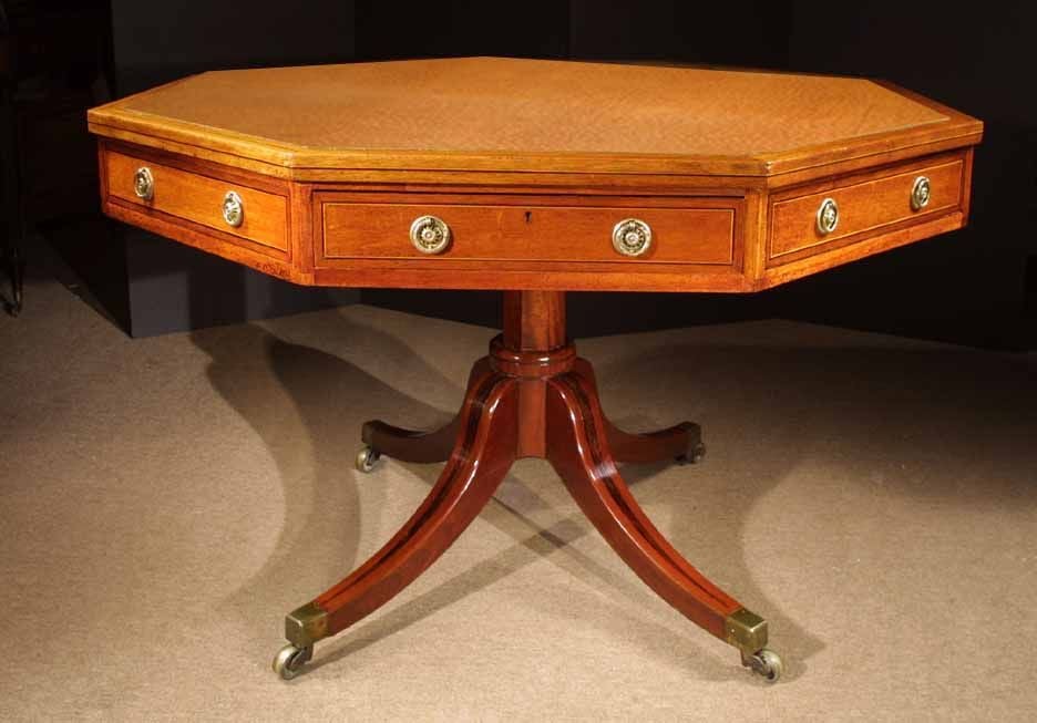 Attractive Regency octagonal drum table neatly executed in mahogany. Note the well balanced proportions and design. The octagonal shaped top with a brown tooled leather surrounded by a crossbanded and reeded edge. The frieze with blind and working