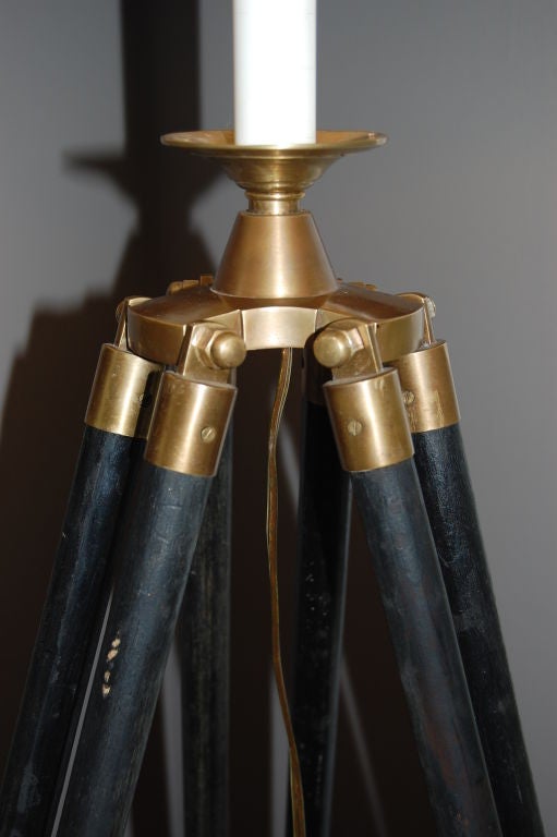 Surveyor's tripod base converted into floor lamp