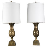 A pair of antique brass pineapple lamps
