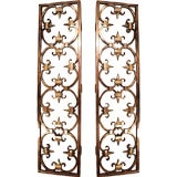 A pair of bronze grilles