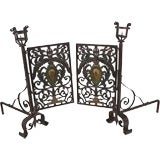 A pair of wrought iron and paint-decorated andirons