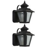 A pair of petite black-painted copper wall lanterns