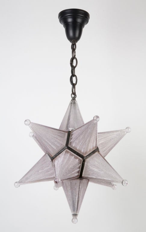 A ten-point amethyst tinted holophane star pendant