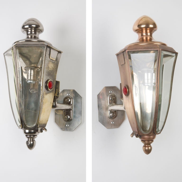 IS2507<br />
A pair of carriage lamps with curved beveled glass panels. Originally on a Pierce Arrow limousine. In their original worn nickelplated finish over bronze. One with distinctly more bronze showing than the other. Signed by the maker