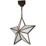 An antique brass star pendant