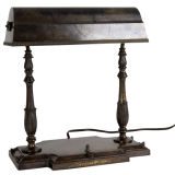An antique bronze and brass desk lamp An antique bronze and brass desk lamp