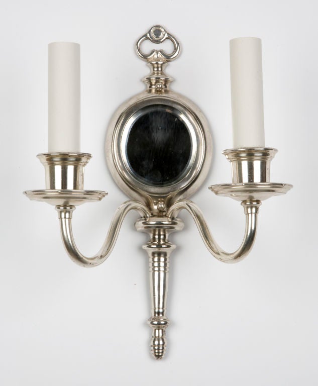 A pair of two arm mirrored sconces