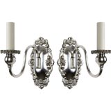 A pair of single-arm silver Sheffield sconces
