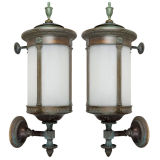 A pair of verdigris bronze cylindrical wall lanterns