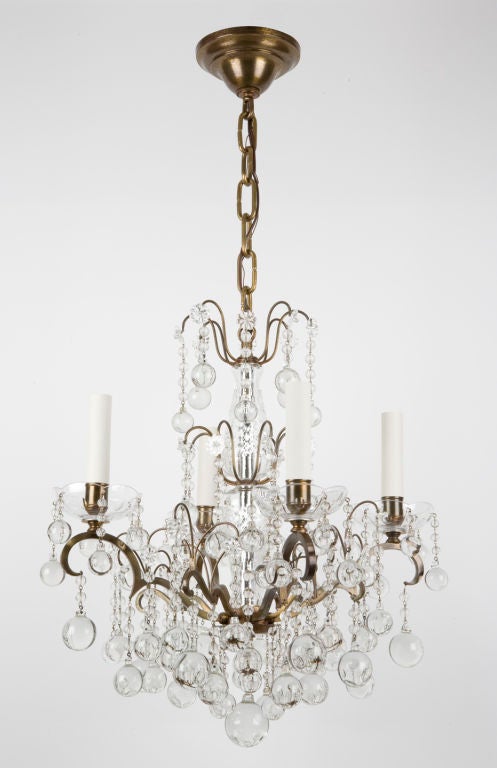 A four-light brass and teardrop crystal chandelier