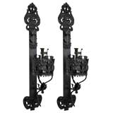 A pair of single arm blackened steel sconces