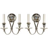 A pair of two-arm silver sconces by the maker Bradley & Hubbard