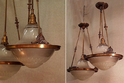 A bronze chandelier with holophane glass lenses