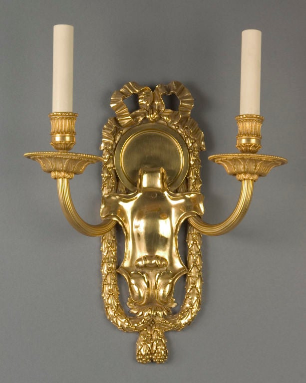 AIS1752

A pair of two arm gilded copper and bronze sconces with cast backplates topped with ribbon details and surrounded by berried swags. Signed by the New York maker E. F. Caldwell. Circa 1910

Dimensions:
Overall: 15