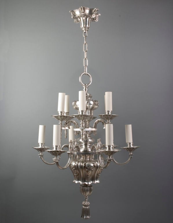 AHL2374

A twelve arm, two tier chandelier in silver plate over cast bronze and copper having incredibly crisp and clear chased foliate and linenfold details. By the Boston maker Pettingell-Andrews Co.

Dimensions:
Current height: 59-1/2