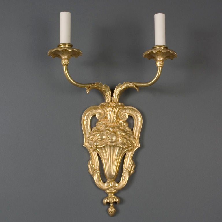 A pair of gilded two-arm sconces by E. F. Caldwell Co.