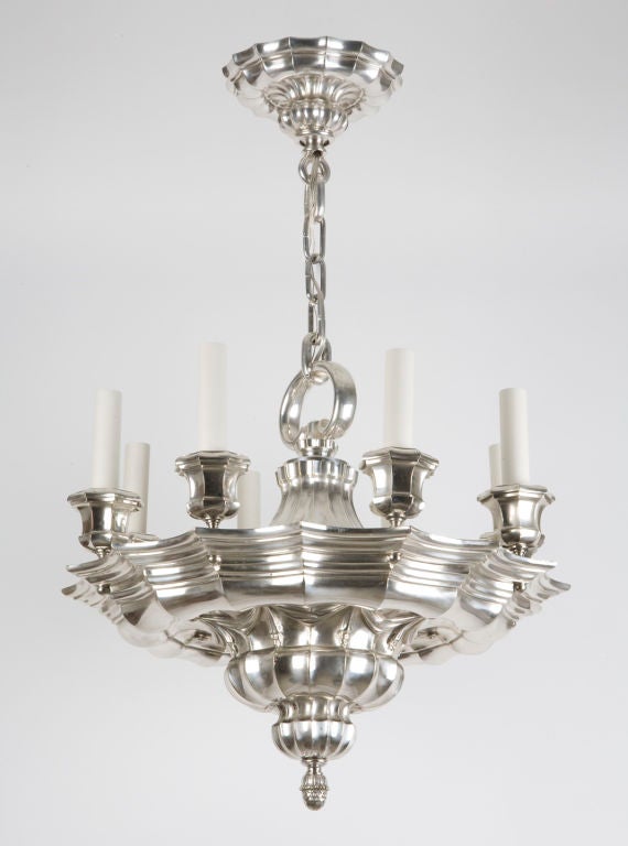 AHL3321

An eight light silverplate chandelier by the New York maker E. F. Caldwell having a massive body detailed with a Baroque layering of ribs and coves. 

Current height: 46 1/2