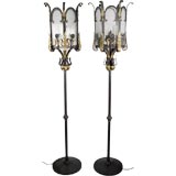 A pair of wrought iron floor lamps