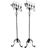 A pair of black iron candelabra floor lamps