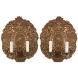 A pair of two arm copper repoussé sconces