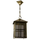 A four sided brass lantern with brass wire-cloth pane