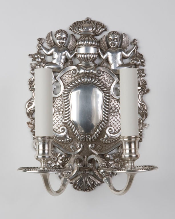 A pair of solid silver double light english sconces