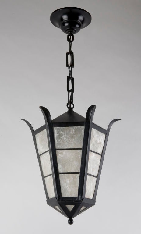 A six sided black iron and capiz shell lantern