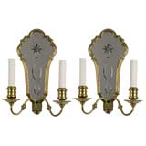 Antique A pair of two arm brass mirror back sconces