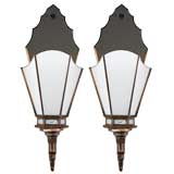 A pair of glass and mirror sconces