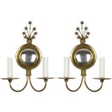 A pair of two arm brass mirrored star sconces