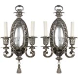 A large pair of two arm silver sconces
