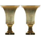 A pair of polished brass uplight sconces