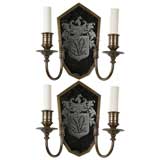 A pair of brass and mirrorback sconces