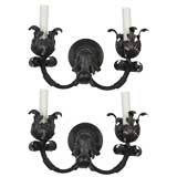 A pair of two arm foliate iron sconces