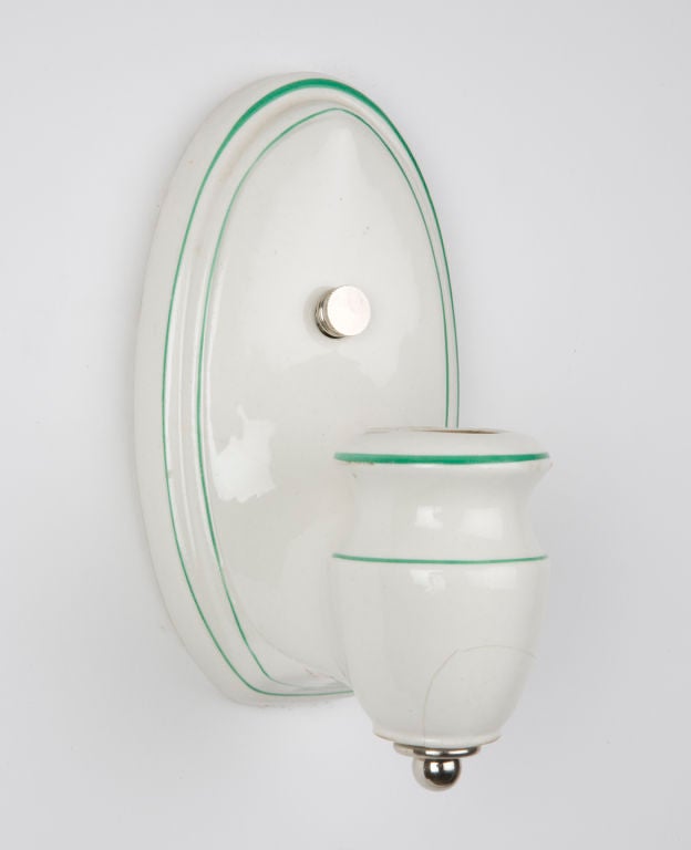 A pair of green pinstriped white porcelain bath sconces