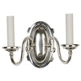 A shield back, two-arm silver sconce