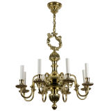 An eight arm polished brass chandelier