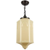 An opaque amber gothic glass pendant